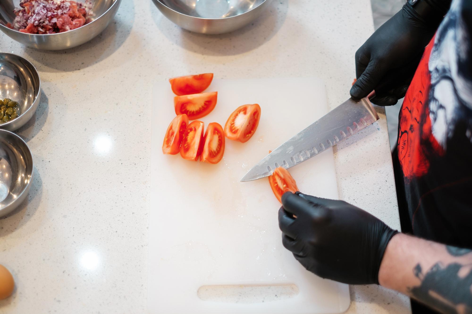 Instructor demonstrating knife technique to a small group